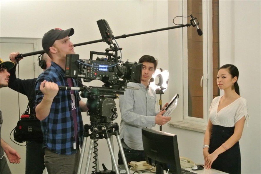 Hong Kong production crew reviewing a shoot on location